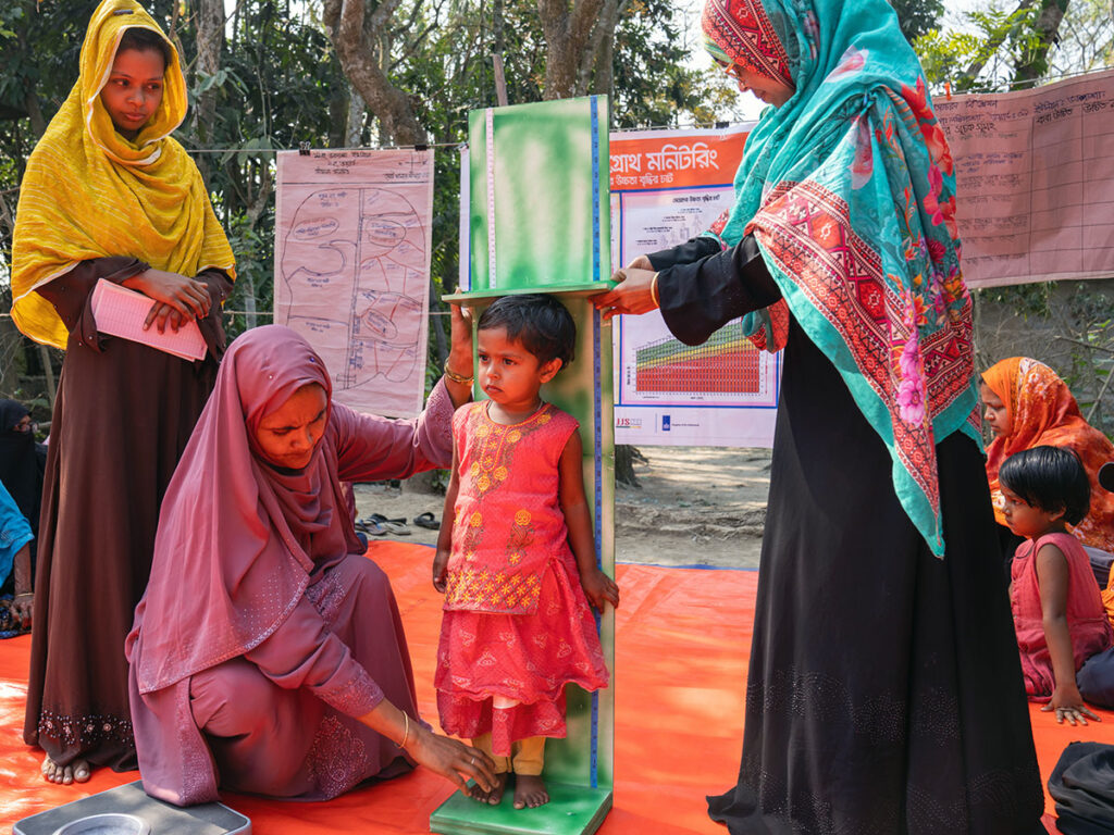 Courtyard Meeting, child measurement Bangladesh