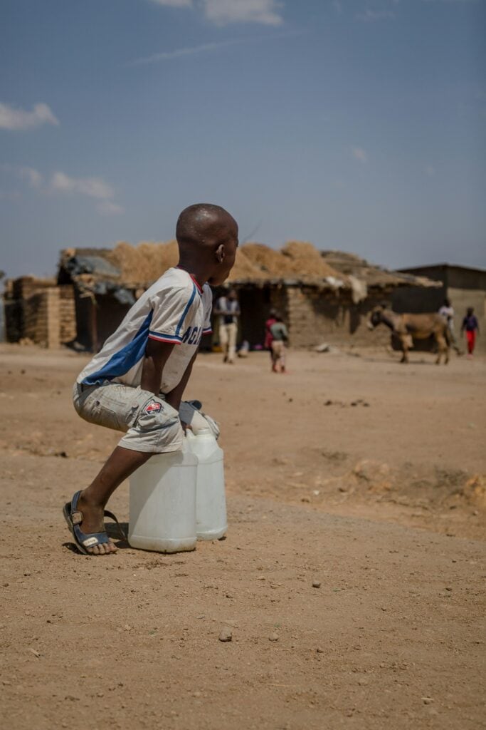Child with water bottles